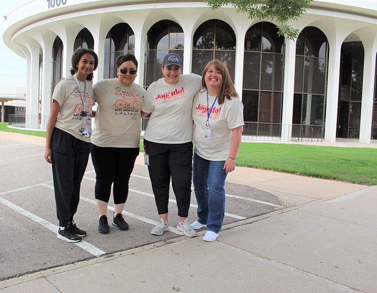 Four friends standing in front of Greeley City Hall