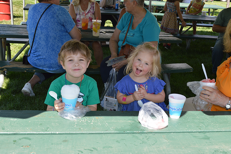 Two children enjoying a snack