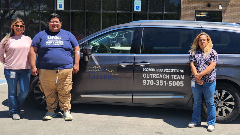 Greeley’s new Homeless Solutions Outreach Team members stand next to their new outreach van.