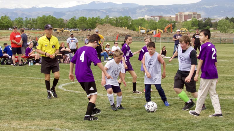 Three members of the Storm Sharks soccer team, Breckson Stockberger, Easton Flannery, and Caleb Thompson-Jump, playing against another team